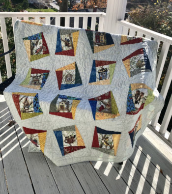 2022 Birding Quilt, "Birds at the Feeder," was designed and pieced by Patricia Loquet. View quilt block details below.